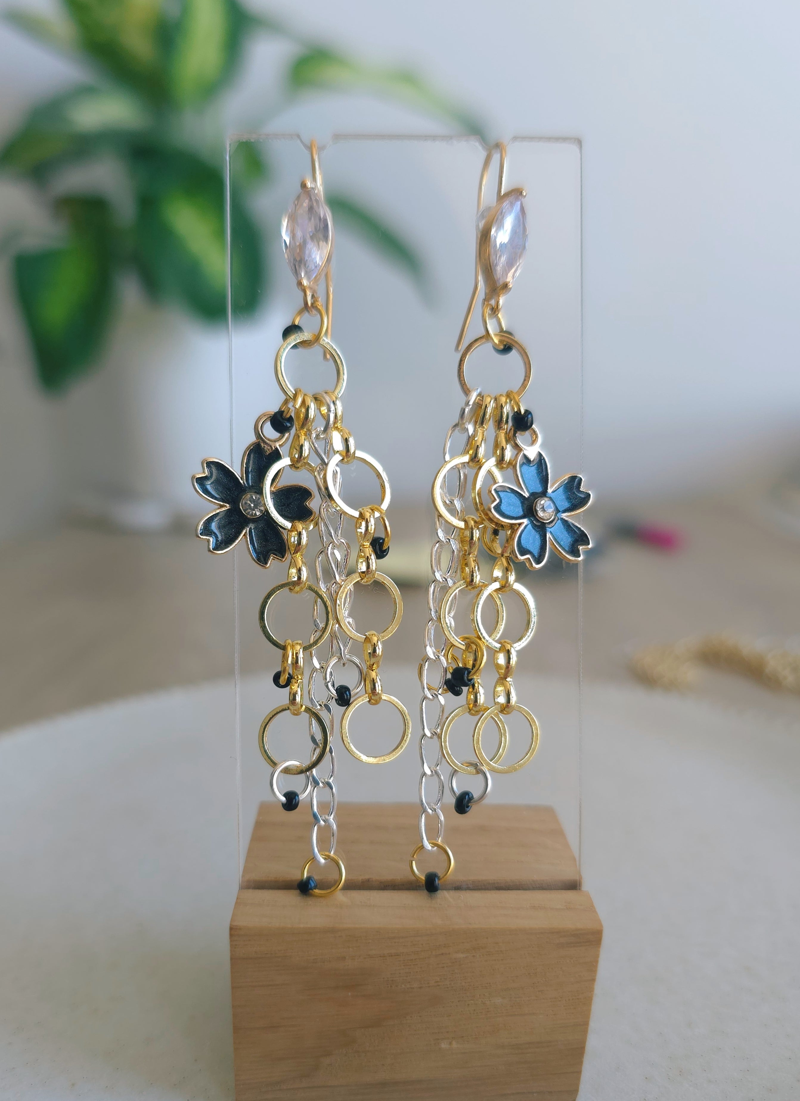 Dreamy chain earrings with black flower charm. Gold plated hooks